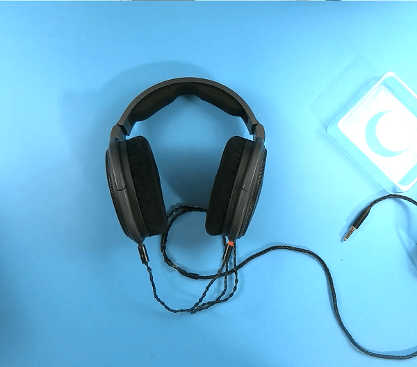 An audio cable plugged into the Sennheiser HD600 headphones