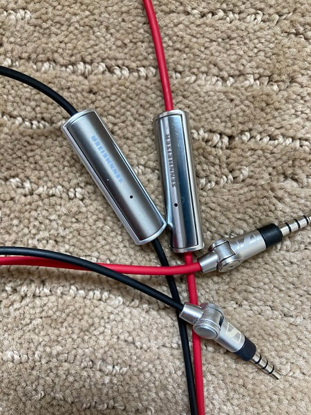 A audio cable on a dirty rug 
