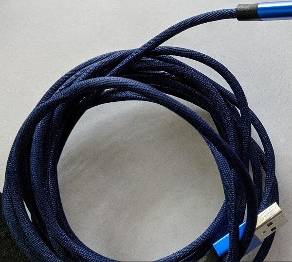 A coiled blue cable on a table