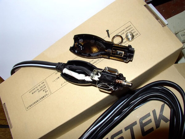A cigarette lighter extension cord, with a connector taken apart