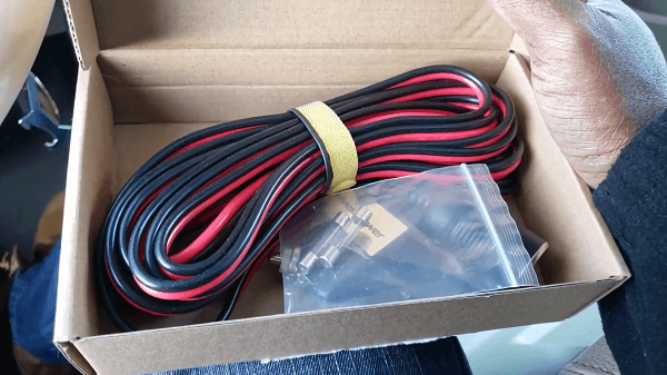 A red and black cable in a freshly opened box