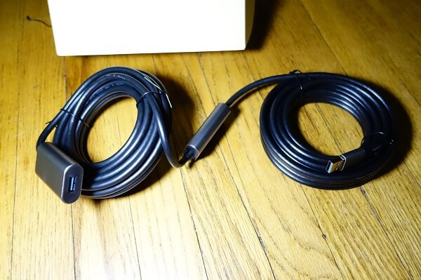 A freshly opened, coiled USB cable on the floor next to the box