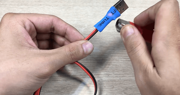 Setting a heat shrink on the cable with a lighter