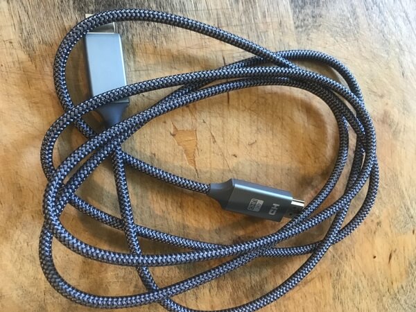 A cable on a desk, coiled less than perfectly 