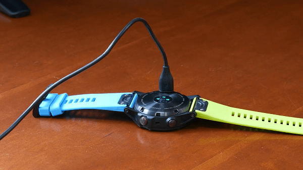 A charging cable plugged into a watch