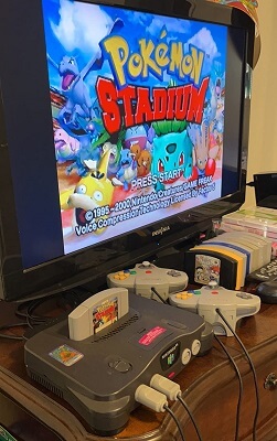 N64 set up and connected to the TV, with a game running
