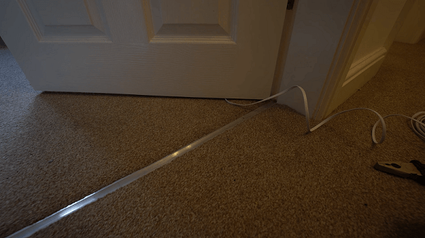 A loose cable going under the door