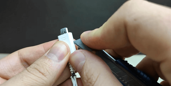 Somebody cutting the connector with a scalpel