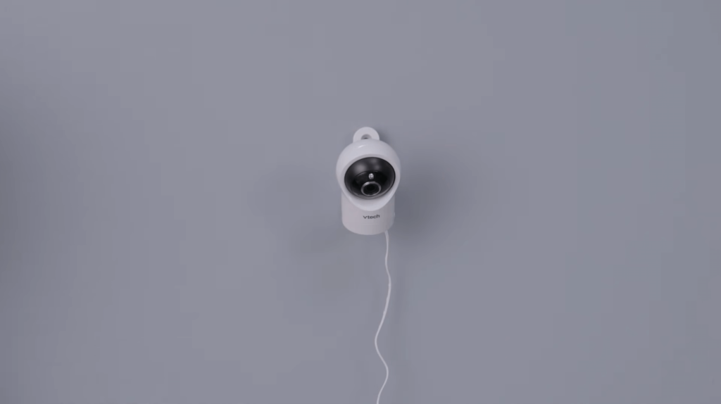 A baby cam, mounted on a wall with an unsecured cord