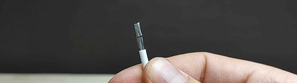 Somebody holding a stripped cable