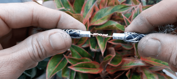 Somebody holding a the cable with wires twisted together