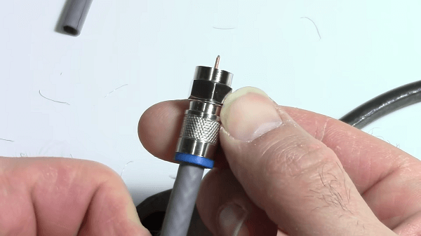Somebody putting a connector on a cable 
