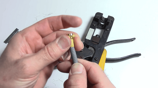 Somebody putting a twist on connector on a cable